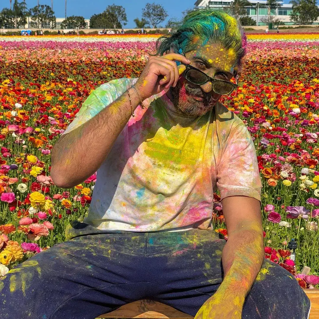 Nishant Sehgal, known as Chef Shanu, smiling during a colorful Holi celebration