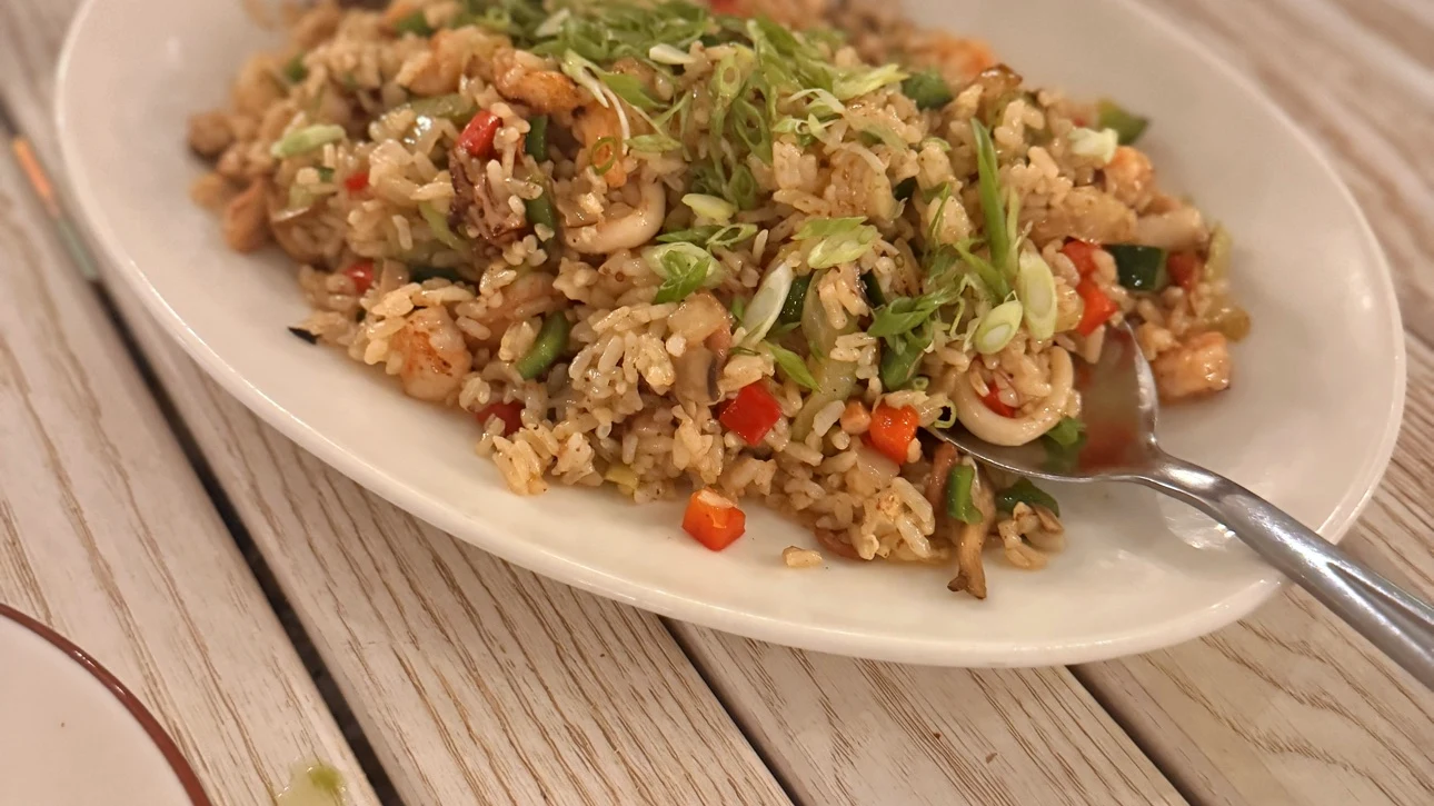 Close-up of La Jollita's Arroz Marinero — shrimp, calamari and peppers folded through seasoned rice